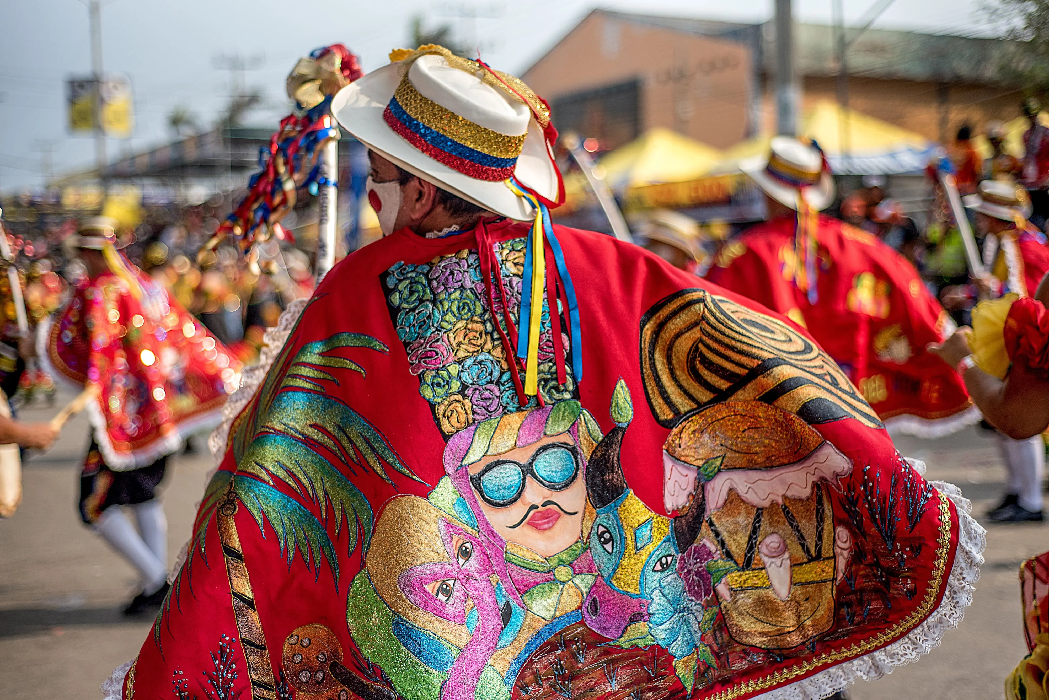 Performers in elaborate feathered and embroidered costumes at Barranquilla's Carnival