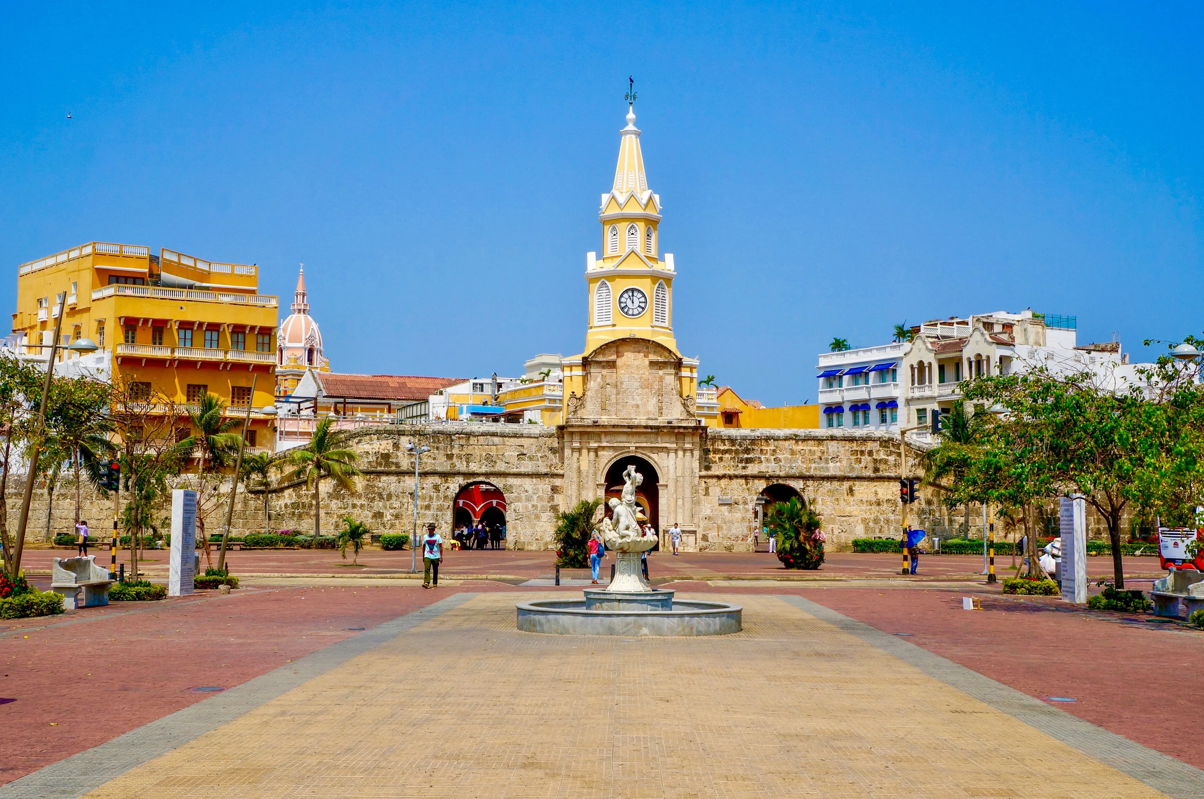 Row of brightly painted colonial buildings with wooden balconies on a Cartagena street