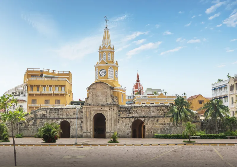 The Torre del Reloj gateway into Cartagena's walled city, with the cathedral dome rising behind it