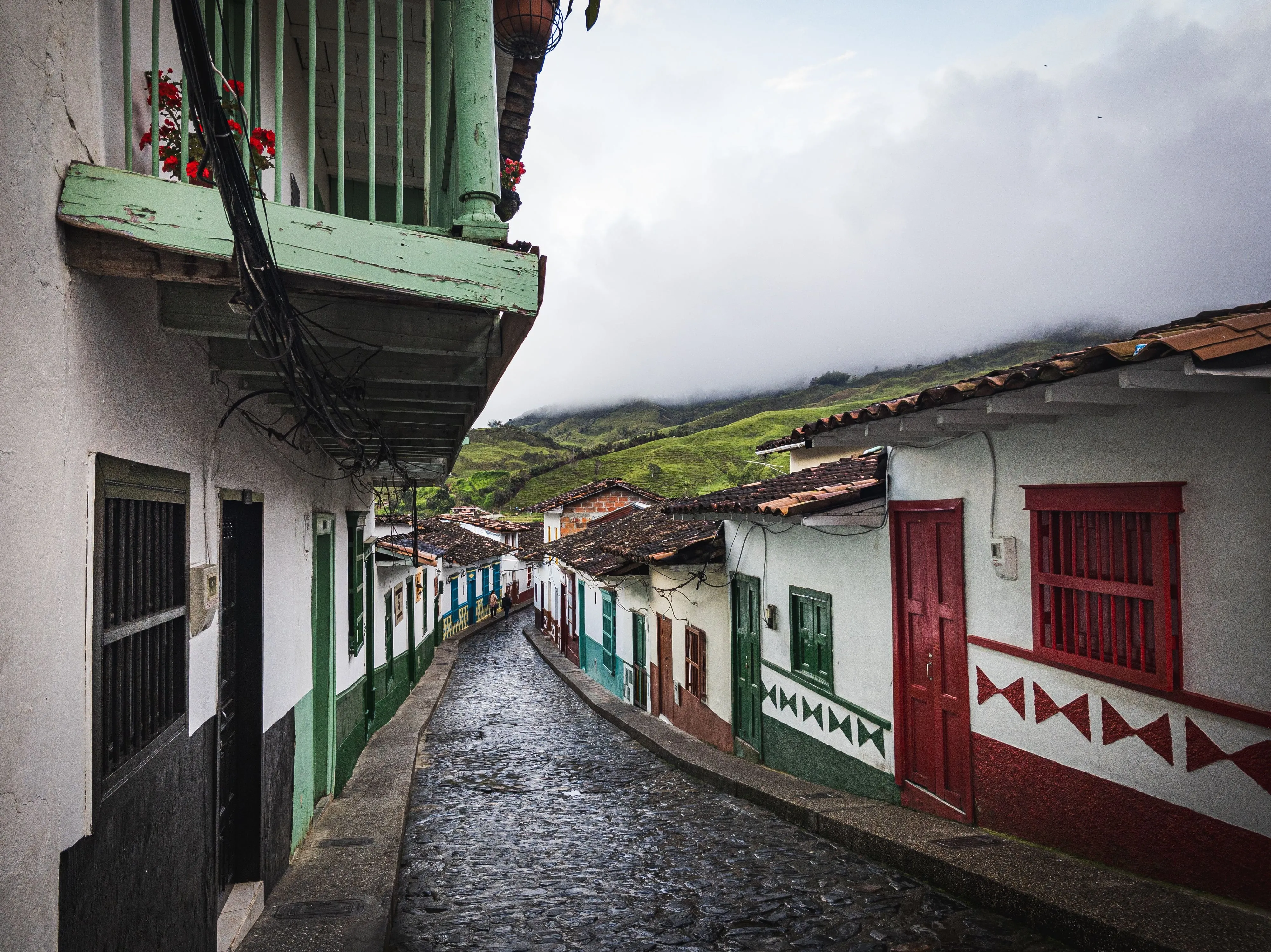 A cobbled street of colonial houses in a Colombian coffee town