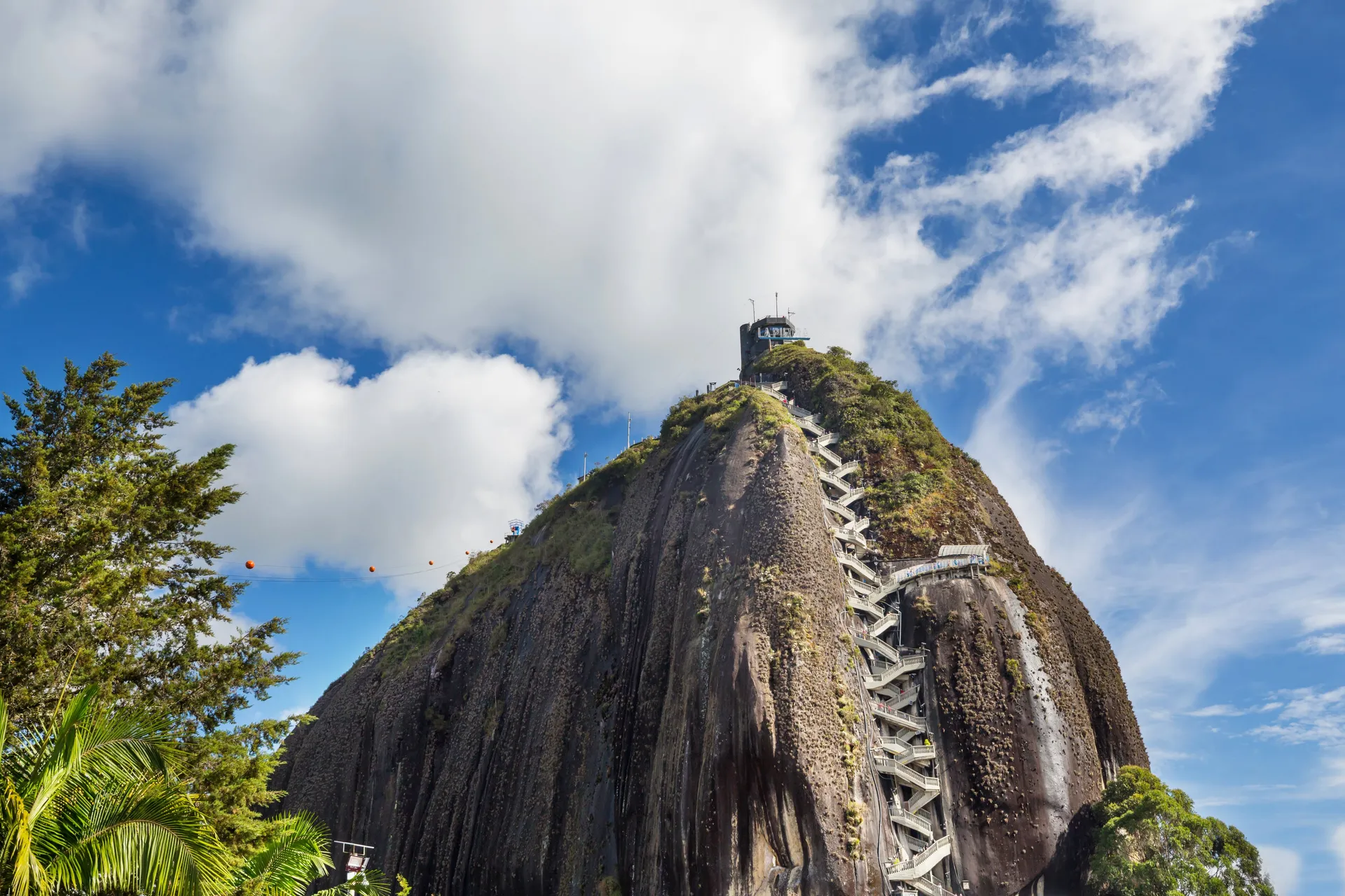 The towering granite monolith of El Peñol rising above the green reservoir near Guatapé
