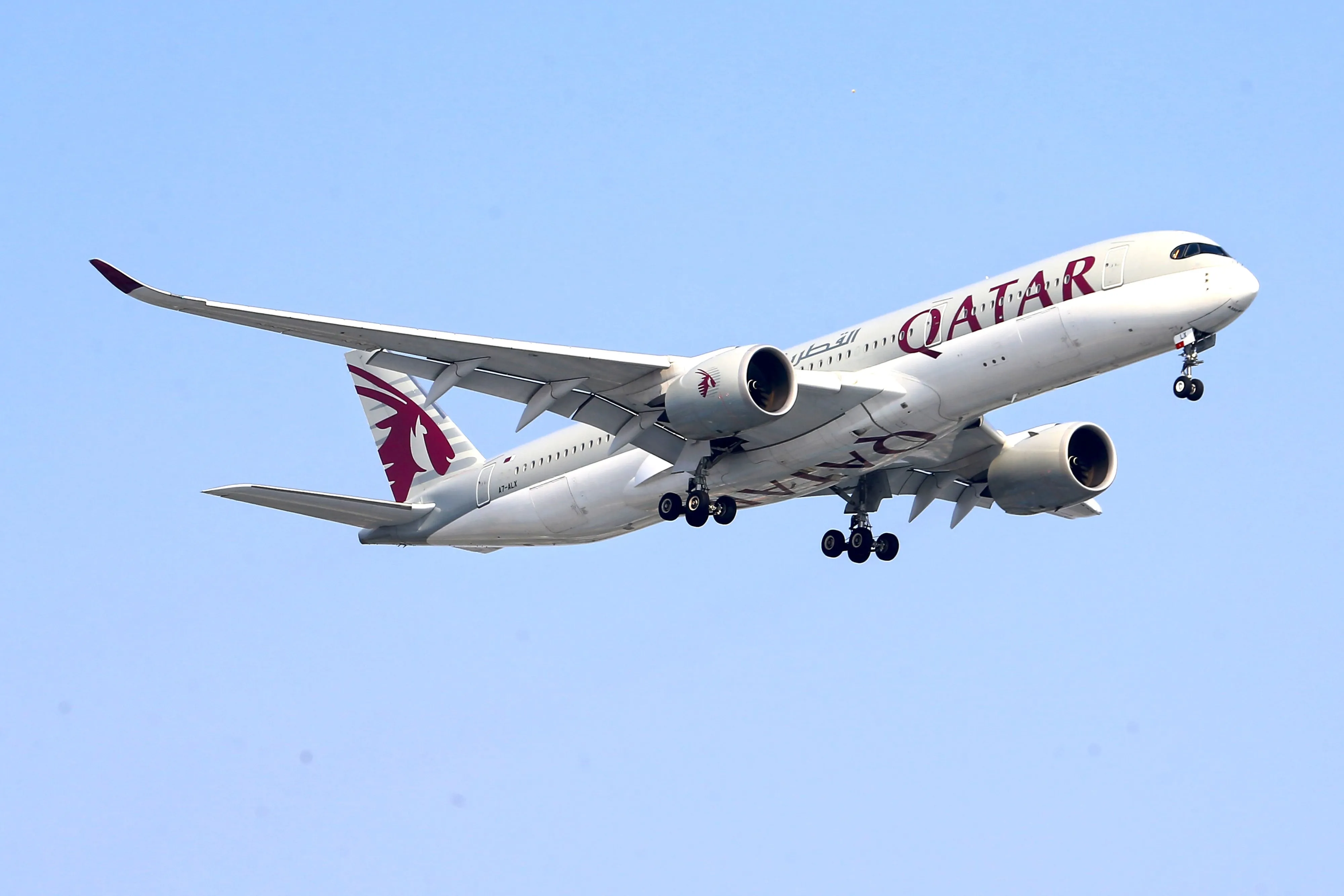 A Qatar Airways Airbus A350 on final approach with its landing gear down